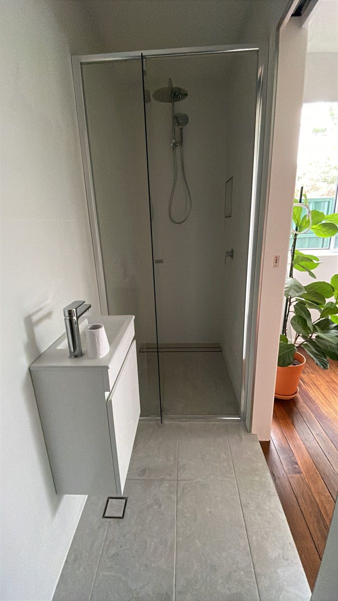 Finished renovated bathroom with walk-in shower and glass screen