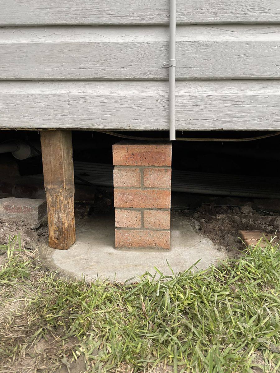 Brick and timber pier supporting a house on a new concrete footing